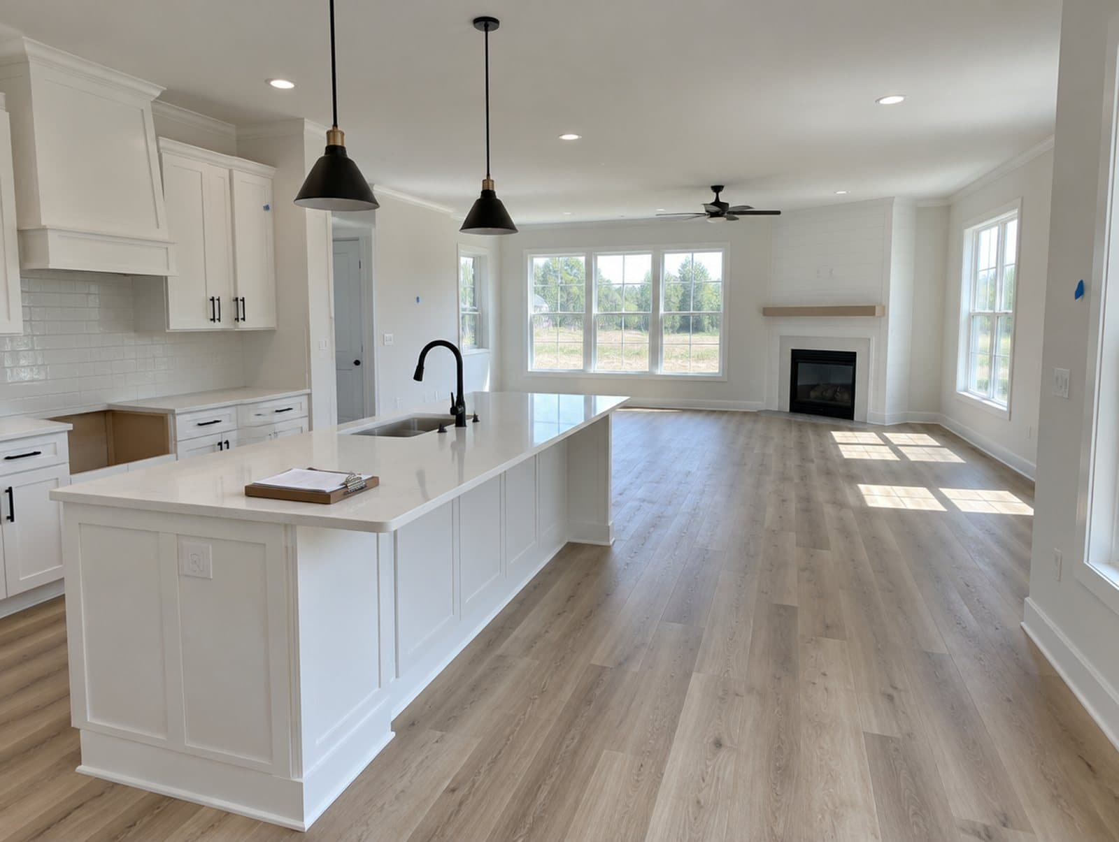 A finished new kitchen with blue tape marking touch-ups before closing