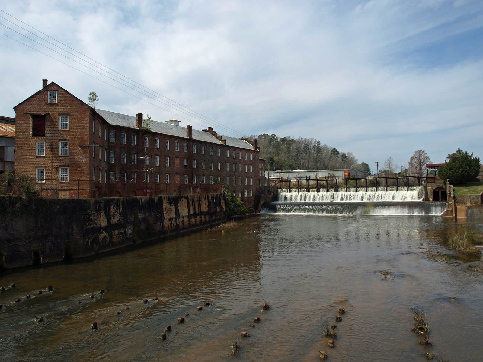 Historic brick Pratt manufacturing buildings and the dam on Autauga Creek